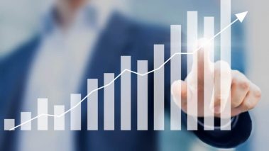 Business success with growing rising charts and businessman in background 3 Under-$10 Growth Stocks to Buy Right Now