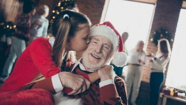 Little girl kissing her granddad at christmastime1 2 Canadian Stocks I’d Buy for a 2021 Santa Rally