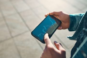 investing app on smartphone Diversified revenue strengthens earnings for Voyager Digital￼
